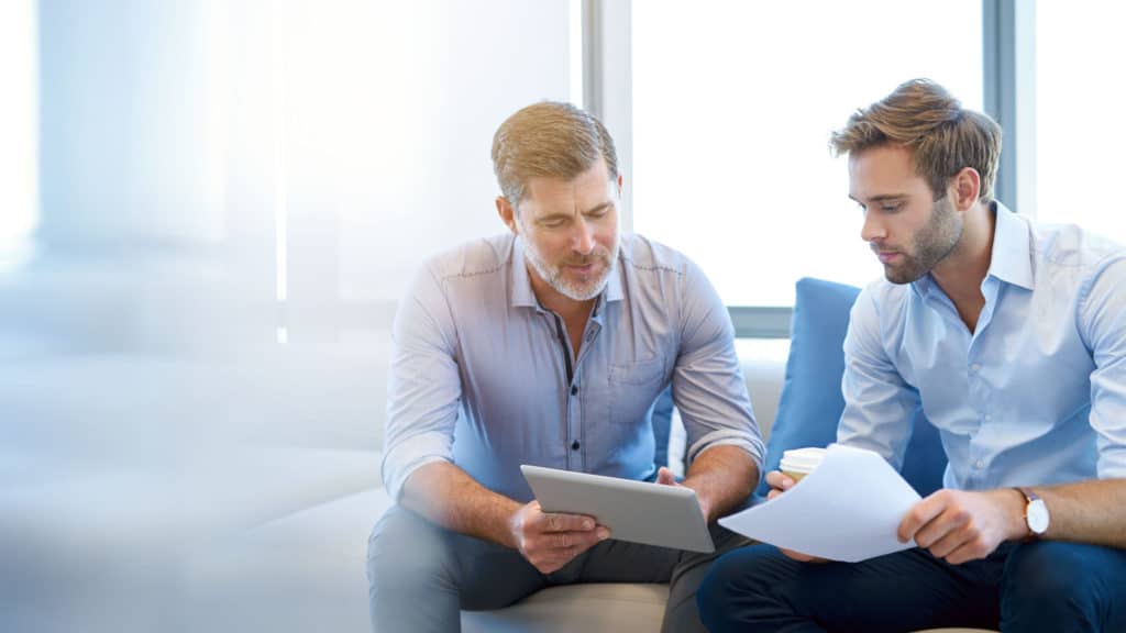 Man Teaching Young Man Information